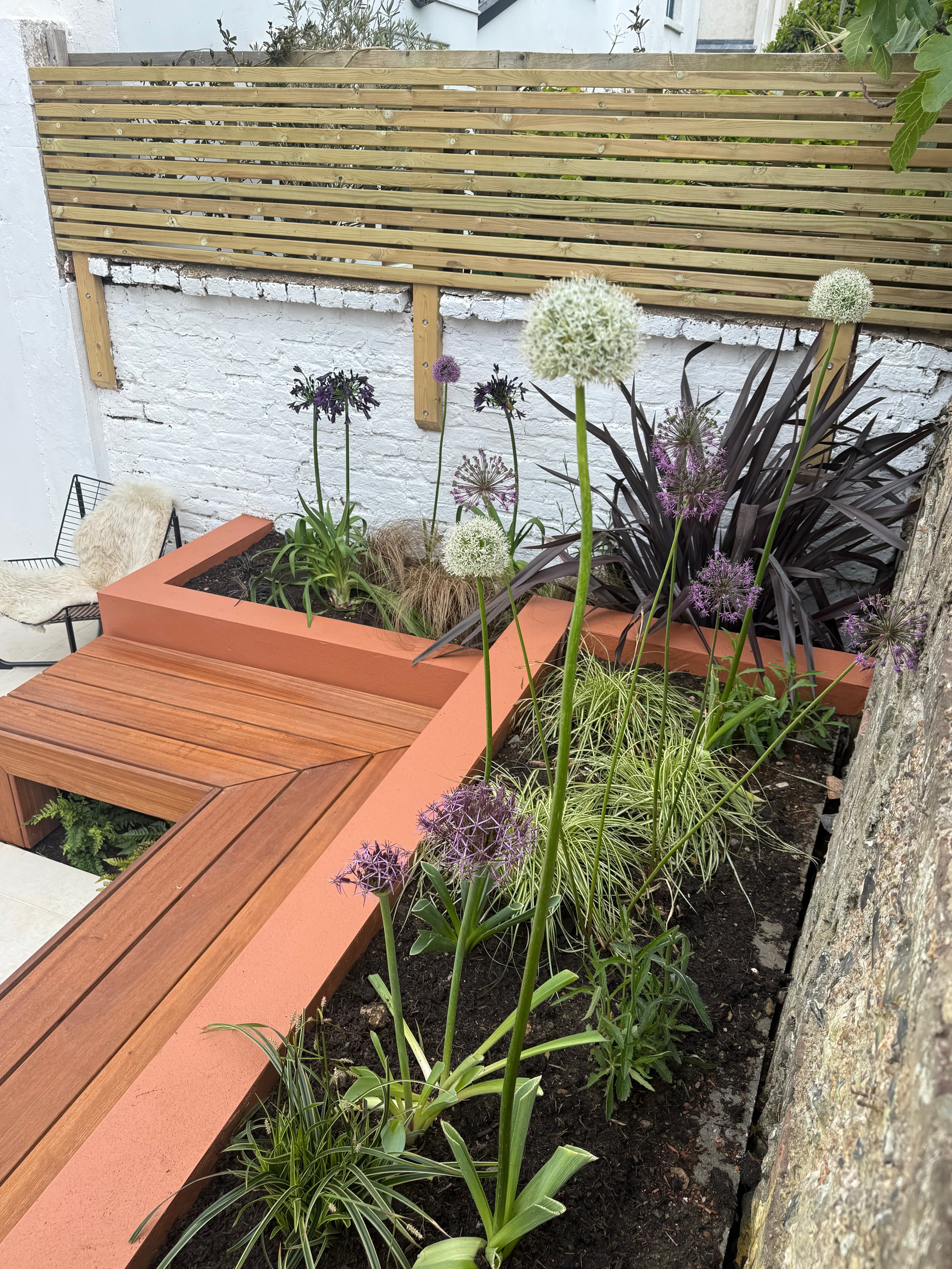 A slatted cedar screen with layered planting